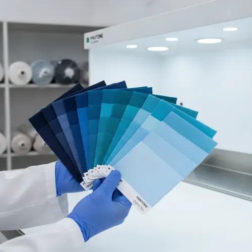Lab dip fabric swatches arranged in gradient rows for color matching and approval during the dyeing and finishing phase.