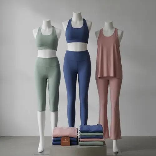Collection of finished premium yoga apparel including leggings, sports bras, and tops made from custom-developed fabric, displayed in a retail-ready presentation.